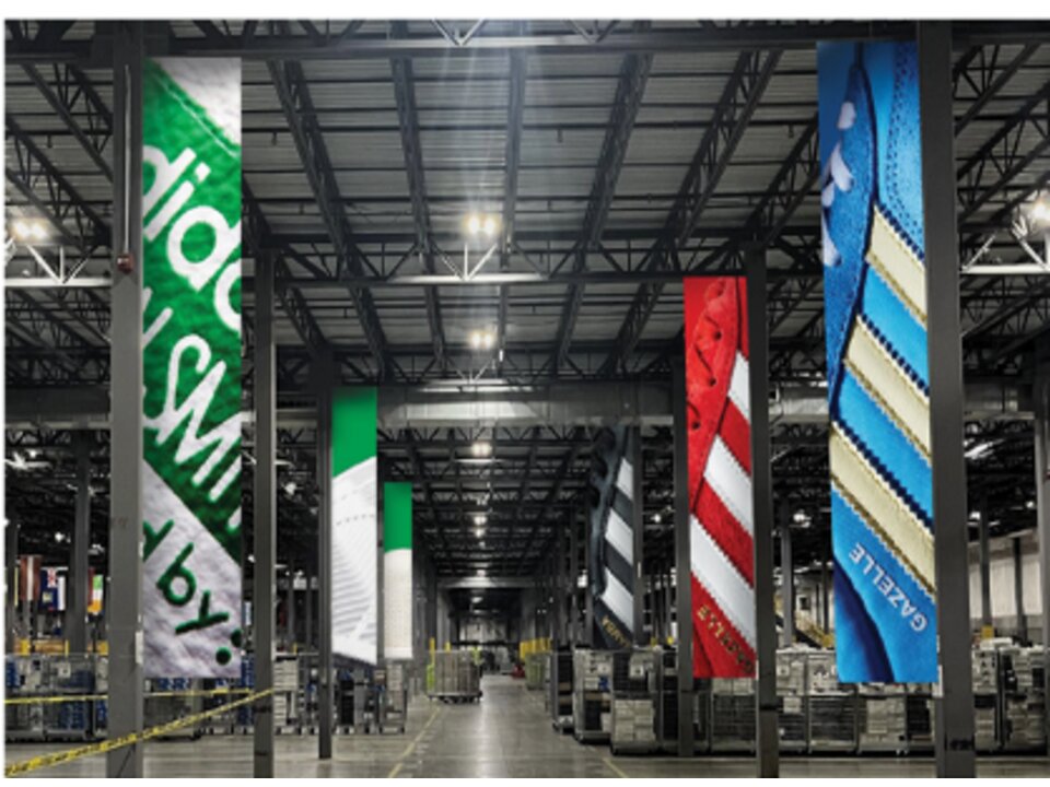 Large-format hanging fabric brand banners in a distribution center