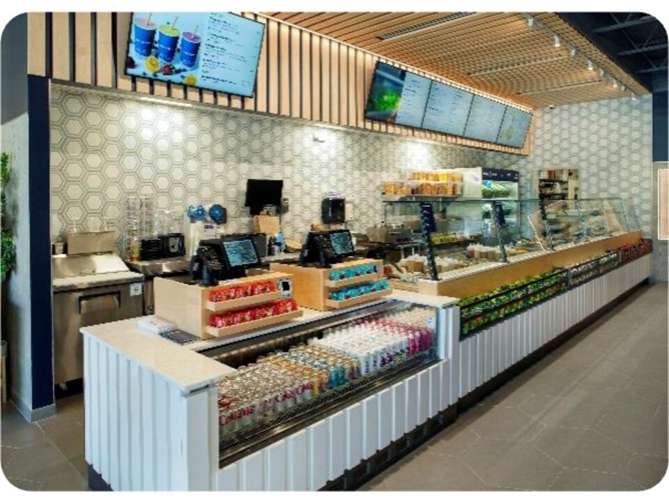 Just Salad interior counter with hexagon tile wall and menu boards
